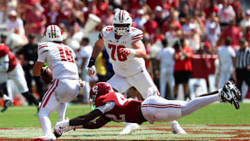 Sep 13, 2025; Tuscaloosa, Alabama, USA; Wisconsin Badgers quarterback Danny O'Neil (18) outruns Alabama Crimson Tide linebacker Yhonzae Pierre (42) during the second half at Saban Field at Bryant-Denny Stadium. Mandatory Credit: David Leong-Imagn Images