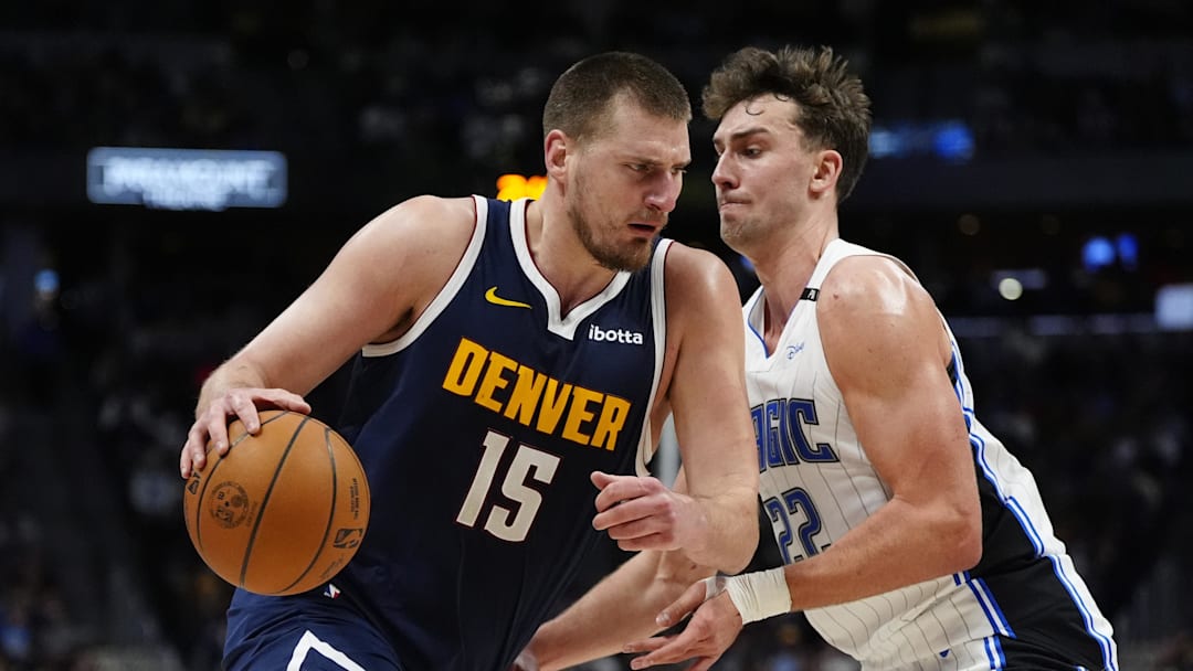 Feb 6, 2025; Denver, Colorado, USA; Denver Nuggets center Nikola Jokic (15) drives against Orlando Magic forward Franz Wagner (22) in the second quarter at Ball Arena.