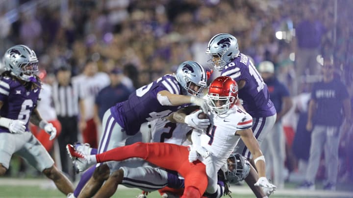 Arizona Wildcats wide receiver Tetairoa McMillan (4) is taken down by Kansas State players during the third quarter of the game at Bill Snyder Family Stadium on Friday, September 13, 2024.