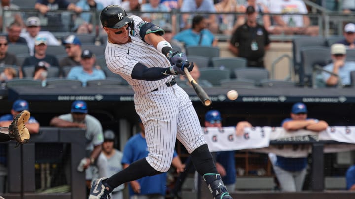 Aug 4, 2024; Bronx, New York, USA; New York Yankees left fielder Aaron Judge (99) singles during the third inning against the Toronto Blue Jays at Yankee Stadium. Mandatory Credit: Vincent Carchietta-USA TODAY Sports