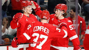 Oct 25, 2025; Detroit, Michigan, USA;  Detroit Red Wings defenseman Simon Edvinsson (77) receives congratulations from teammates after scoring in the third period against the St. Louis Blues at Little Caesars Arena. Mandatory Credit: Rick Osentoski-Imagn Images