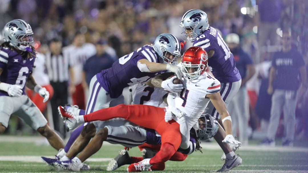 Arizona Wildcats wide receiver Tetairoa McMillan (4) is taken down by Kansas State players during the third quarter of the game at Bill Snyder Family Stadium on Friday, September 13, 2024.