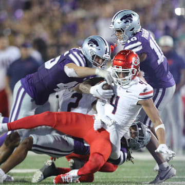 Arizona Wildcats wide receiver Tetairoa McMillan (4) is taken down by Kansas State players during the third quarter of the game at Bill Snyder Family Stadium on Friday, September 13, 2024.