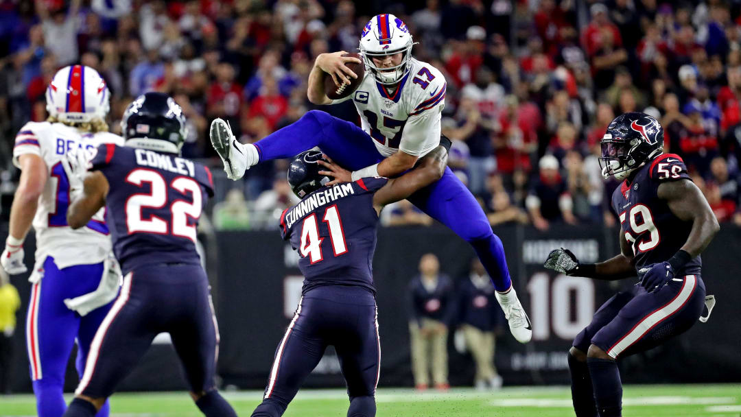 Jan 4, 2020; Houston, Texas, USA;  Buffalo Bills quarterback Josh Allen (17) tries to jump over Houston Texans inside linebacker Zach Cunningham (41) during overtime in the AFC Wild Card NFL Playoff game at NRG Stadium. Kevin Jairaj-USA TODAY Sports