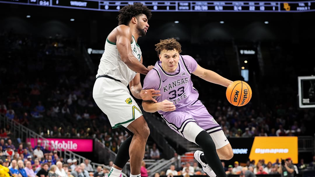 Mar 12, 2025; Kansas City, MO, USA; Kansas State Wildcats guard Coleman Hawkins (33) drives to the basket around Baylor Bears forward Norchad Omier (15) during the second half at T-Mobile Center. Mandatory Credit: William Purnell-Imagn Images