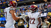 Oct 5, 2025; Inglewood, California, USA; Washington Commanders running back Jacory Croskey-Merritt (22) celebrates with tight end John Bates (87) after scoring a touchdown against the Los Angeles Chargers in the second half at SoFi Stadium. Mandatory Credit: Gary A. Vasquez-Imagn Images