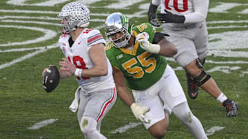 Ohio State Buckeyes quarterback Will Howard (18), Oregon Ducks defensive lineman Derrick Harmon (55) 