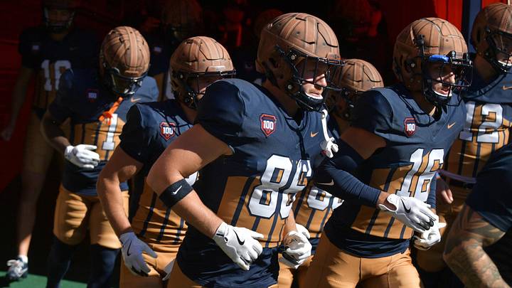 Oct 19, 2024; Champaign, Illinois, USA;  Illinois Fighting Illini players wear the throwback helmets and uniforms in honor of legendary Red Grange and the 100th anniversary of Memorial Stadium before the game against the Michigan Wolverines. Mandatory Credit: Ron Johnson-Imagn Images