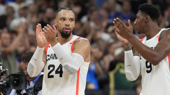 Jul 30, 2024; Villeneuve-d'Ascq, France; Canada small forward Dillon Brooks (24) and Canada small forward RJ Barrett (9) celebrate defeating Australia in a men's group stage basketball match during the Paris 2024 Olympic Summer Games at Stade Pierre-Mauroy.