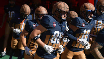 Oct 19, 2024; Champaign, Illinois, USA;  Illinois Fighting Illini players wear the throwback helmets and uniforms in honor of legendary Red Grange and the 100th anniversary of Memorial Stadium before the game against the Michigan Wolverines. Mandatory Credit: Ron Johnson-Imagn Images