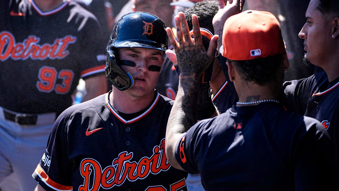 Detroit Tigers infielder Kevin McGonigle high-fives shortstop Javier Báez in the dugout after scoring a run against New York Yankees during the first inning at George M. Steinbrenner Field in Tampa, Fla. on Saturday, Feb. 21, 2026.