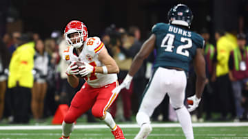 Feb 9, 2025; New Orleans, LA, USA;  Kansas City Chiefs tight end Travis Kelce (87) catches a pass against Philadelphia Eagles linebacker Oren Burks (42) in the fourth quarter in Super Bowl LIX at Ceasars Superdome. Mandatory Credit: Mark J. Rebilas-Imagn Images