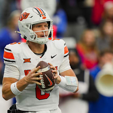 Nov 1, 2025; Lawrence, Kansas, USA; Oklahoma State Cowboys quarterback Zane Flores (6) drops back to pass during the second half against the Kansas Jayhawks at David Booth Kansas Memorial Stadium. Mandatory Credit: Jay Biggerstaff-Imagn Images
