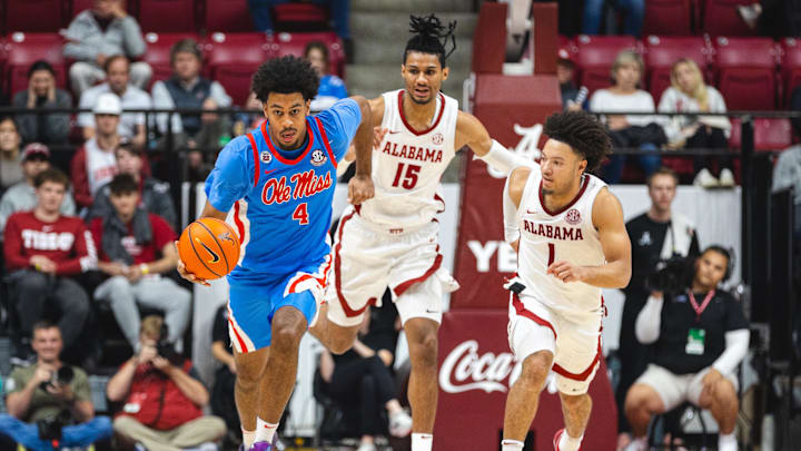Jan 14, 2025; Tuscaloosa, Alabama, USA; Mississippi Rebels forward Jaemyn Brakefield (4) drives the ball against Alabama Crimson Tide forward Jarin Stevenson (15) and guard Mark Sears (1) during the second half at Coleman Coliseum. Mandatory Credit: Will McLelland-Imagn Images