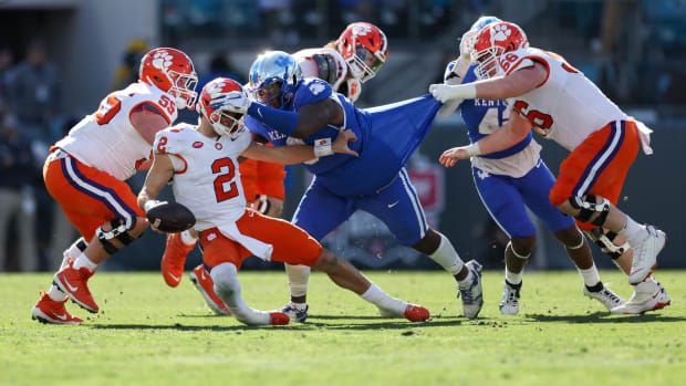 Dec 29, 2023; Jacksonville, FL, USA;  Clemson Tigers quarterback Cade Klubnik (2) is brought down by Kentucky Wildcats defensive lineman Deone Walker (0) in the third quarter during the Gator Bowl at EverBank Stadium. Mandatory Credit: Nathan Ray Seebeck-USA TODAY Sports