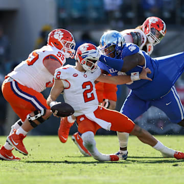 Dec 29, 2023; Jacksonville, FL, USA;  Clemson Tigers quarterback Cade Klubnik (2) is brought down by Kentucky Wildcats defensive lineman Deone Walker (0) in the third quarter during the Gator Bowl at EverBank Stadium. Mandatory Credit: Nathan Ray Seebeck-Imagn Images