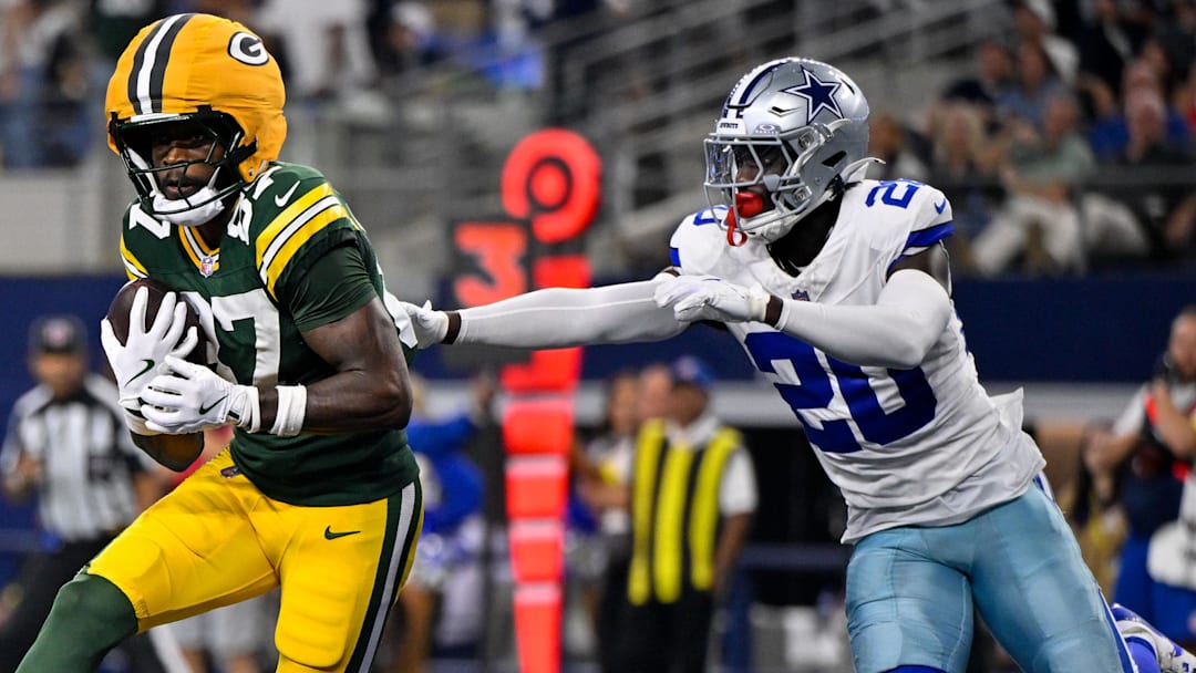 Sep 28, 2025; Arlington, Texas, USA; Green Bay Packers wide receiver Romeo Doubs (87) catches a pass for a touchdown in front of Dallas Cowboys cornerback Kaiir Elam (20) during the game between the Dallas Cowboys and the Green Bay Packers at AT&T Stadium