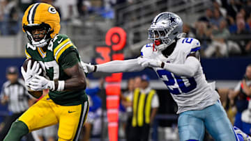 Sep 28, 2025; Arlington, Texas, USA; Green Bay Packers wide receiver Romeo Doubs (87) catches a pass for a touchdown in front of Dallas Cowboys cornerback Kaiir Elam (20) during the game between the Dallas Cowboys and the Green Bay Packers at AT&T Stadium