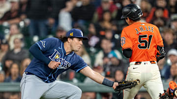San Francisco Giants center fielder Jung Hoo Lee (51) is tagged out by Tampa Bay Rays first baseman Bob Seymour Friday night.