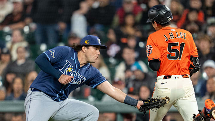 San Francisco Giants center fielder Jung Hoo Lee (51) is tagged out by Tampa Bay Rays first baseman Bob Seymour Friday night.