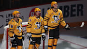 Oct 9, 2025; Pittsburgh, Pennsylvania, USA;  Pittsburgh Penguins defenseman Kris Letang (58) and center Sidney Crosby (87) and center Evgeni Malkin (71) stand as they are recognized as the longest tenured teammates in North American professional sports history before their twentieth season together prior to the game against the New York Islanders at PPG Paints Arena. Mandatory Credit: Charles LeClaire-Imagn Images