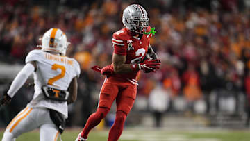 Dec 21, 2024; Columbus, Ohio, USA; Ohio State Buckeyes wide receiver Emeka Egbuka (2) catches a pass against Tennessee Volunteers defensive back Andre Turrentine (2) during the first half of a College Football Playoff first round game at Ohio Stadium. Mandatory Credit: Adam Cairns-Imagn Images