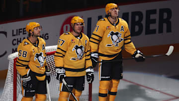Oct 9, 2025; Pittsburgh, Pennsylvania, USA;  Pittsburgh Penguins defenseman Kris Letang (58) and center Sidney Crosby (87) and center Evgeni Malkin (71) stand as they are recognized as the longest tenured teammates in North American professional sports history before their twentieth season together prior to the game against the New York Islanders at PPG Paints Arena. Mandatory Credit: Charles LeClaire-Imagn Images