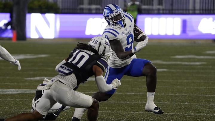 Sep 6, 2024; Evanston, Illinois, USA; Northwestern Wildcats defensive back Theran Johnson (10) tackles Duke Blue Devils running back Jaquez Moore (9) during the first half at Lanny and Sharon Martin Stadium. Mandatory Credit: David Banks-Imagn Images