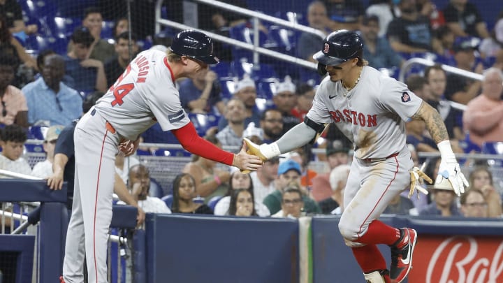 Jul 2, 2024; Miami, Florida, USA; Boston Red Sox left fielder Jarren Duran (16) celebrates his home run with  third base coach Kyle Hudson (84) against the Miami Marlins in the eighth inning at loanDepot Park.