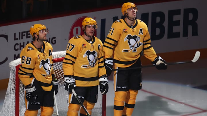Oct 9, 2025; Pittsburgh, Pennsylvania, USA;  Pittsburgh Penguins defenseman Kris Letang (58) and center Sidney Crosby (87) and center Evgeni Malkin (71) stand as they are recognized as the longest tenured teammates in North American professional sports history before their twentieth season together prior to the game against the New York Islanders at PPG Paints Arena.