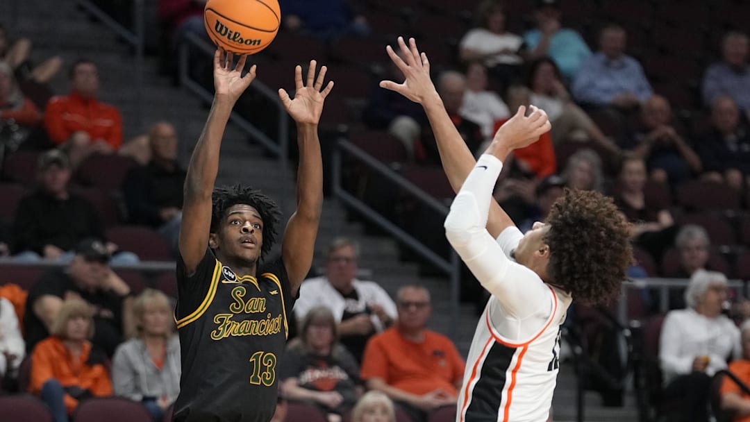 March 8, 2026; Las Vegas, NV, USA; San Francisco Dons guard Legend Smiley (13) shoots the basketball against Oregon State Beavers forward Isaiah Sy (13) during the first half at Orleans Arena. Mandatory Credit: Kyle Terada-Imagn Images