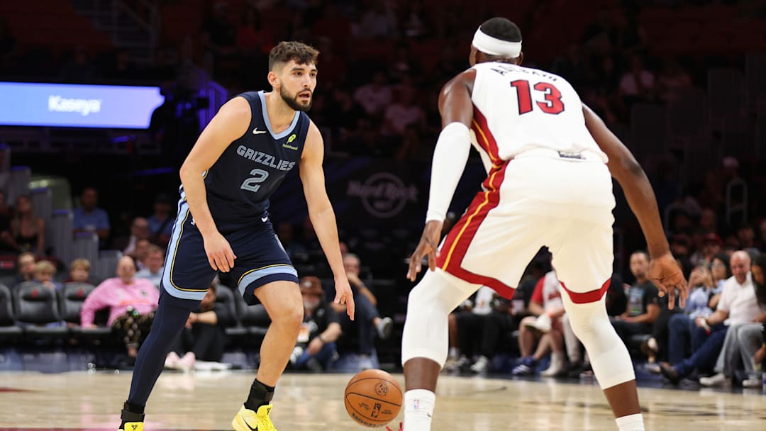Oct,17, 2025; Miami, Florida, USA; Grizzlies guard Ty Jerome (2) being defended by Bam Adebayo (13) during the Grizzlies' preseason game against the Miami Heat. 