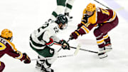 Michigan State's Isaac Howard, left, moves the puck as Minnesota's Oliver Moore, right, defends during the first period on Friday, Jan. 26, 2024, at Munn Arena in East Lansing.
