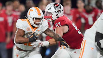 Tennessee running back DeSean Bishop (18) is defended by N.C. State defensive edge Noah Potter (97) at the NCAA College football game between Tennessee and NC State on Saturday, Sept. 7, 2024 in Charlotte, NC.