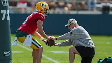 Green Bay Packers quarterbacks coach Tom Clements snaps the ball to quarterback Sean Clifford (6) in a drill during practice on Wednesday, August 14, 2024, at Ray Nitschke Field in Ashwaubenon, Wis. 
Tork Mason/USA TODAY NETWORK-Wisconsin