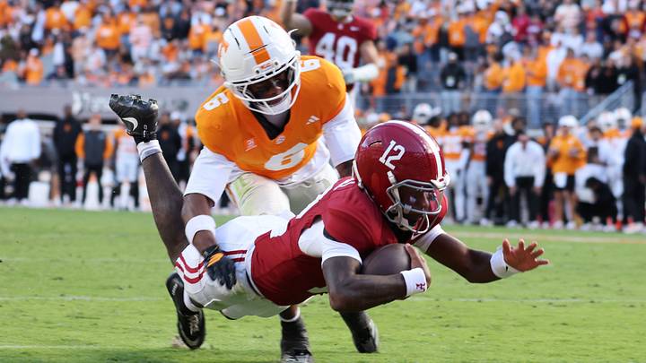 Oct 17, 2026; Knoxville, Tennessee, USA;  Alabama Crimson Tide quarterback Keelon Russell (12) dives to score a touchdown against Tennessee Volunteers defensive back Qua Moss (6) during the first half at Neyland Stadium.  Mandatory Credit: Randy Sartin-Imagn Images