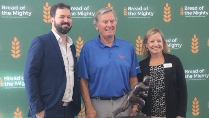 Patrick Dodds, left, the executive director of Bread of the Mighty, stands with former University of Football head coach and quarterback Steve Spurrier, center, and Susan King, the CEO of Feeding Northeast Florida, during the 2023 Empty Bowls luncheon fundraiser.