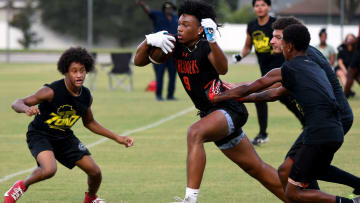 A Lake Wales receiver works to avoid a tackle during the Polk 7 on 7 passing tournament Friday at Lake Myrtle Park in Auburndale.