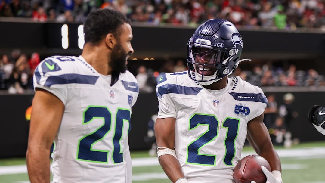 Dec 7, 2025; Atlanta, Georgia, USA; Seattle Seahawks cornerback Devon Witherspoon (21) celebrates with safety Julian Love (20) after an interception against the Atlanta Falcons in the fourth quarter at Mercedes-Benz Stadium. Mandatory Credit: Brett Davis-Imagn Images