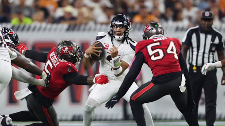 Sep 15, 2025; Houston, Texas, USA; Houston Texans quarterback C.J. Stroud (7) comes under pressure from Tampa Bay Buccaneers linebacker Lavonte David (54) and Tampa Bay Buccaneers linebacker Haason Reddick (5) during the third quarter at NRG Stadium. Mandatory Credit: Troy Taormina-Imagn Images