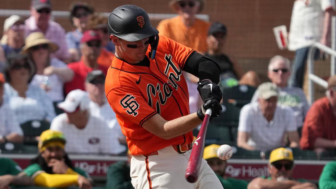 Feb 23, 2026; Scottsdale, Arizona, USA; San Francisco Giants catcher Daniel Susac (6) hits a single against the Athletics in the third inning at Scottsdale Stadium. Mandatory Credit: Rick Scuteri-Imagn Images
