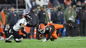 Nov 16, 2025; Cleveland, Ohio, USA; Cleveland Browns quarterback Shedeur Sanders (12) dives for a gain past Baltimore Ravens safety Alohi Gilman (12) during the fourth quarter at Huntington Bank Field. Mandatory Credit: Scott Galvin-Imagn Images