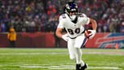 Jan 19, 2025; Orchard Park, New York, USA; Baltimore Ravens tight end Isaiah Likely (80) runs the ball after making a catch during the first quarter against the Buffalo Bills in a 2025 AFC divisional round game at Highmark Stadium.