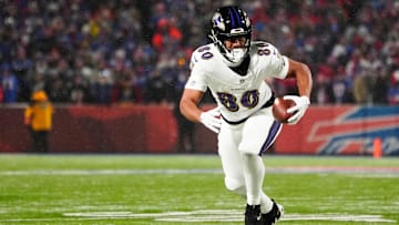 Jan 19, 2025; Orchard Park, New York, USA; Baltimore Ravens tight end Isaiah Likely (80) runs the ball after making a catch during the first quarter against the Buffalo Bills in a 2025 AFC divisional round game at Highmark Stadium.