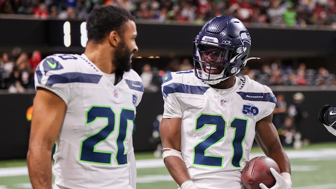 Dec 7, 2025; Atlanta, Georgia, USA; Seattle Seahawks cornerback Devon Witherspoon (21) celebrates with safety Julian Love (20) after an interception against the Atlanta Falcons in the fourth quarter at Mercedes-Benz Stadium.