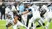 Oct 12, 2025; Paradise, Nevada, USA; Las Vegas Raiders defensive tackle Leki Fotu (95) sacks Tennessee Titans quarterback Cam Ward (1) during the second half at Allegiant Stadium. Mandatory Credit: Stephen R. Sylvanie-Imagn Images