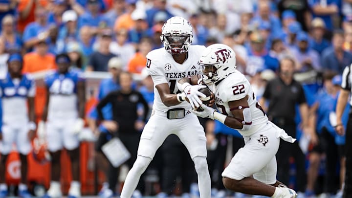 Sep 14, 2024; Gainesville, Florida, USA; Texas A&M Aggies quarterback Marcel Reed (10) hands the ball to Texas A&M Aggies running back EJ Smith (22) against the Florida Gators during the first half at Ben Hill Griffin Stadium. Mandatory Credit: Matt Pendleton-Imagn Images