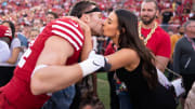 San Francisco 49ers fullback Kyle Juszczyk (44) kisses wife Kristin Juszczyk (right) before the game against the New Orleans Saints at Levi's Stadium.