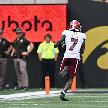 Sep 14, 2024; Iowa City, Iowa, USA; Troy Trojans wide receiver Devonte Ross (7) catches a 63 yard touchdown pass from quarterback Matthew Caldwell (not pictured) as Iowa Hawkeyes defensive back TJ Hall (2) pursues during the second quarter at Kinnick Stadium. Mandatory Credit: Jeffrey Becker-Imagn Images