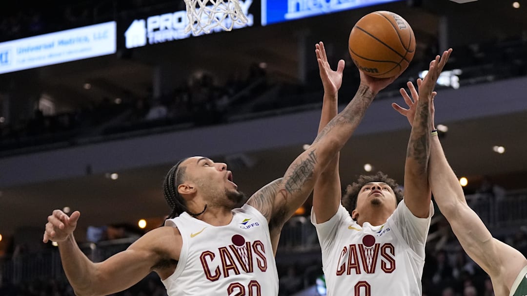 Feb 25, 2026; Milwaukee, Wisconsin, USA;  Cleveland Cavaliers forward Jaylon Tyson (20), guard Craig Porter Jr. (9) a dnMilwaukee Bucks guard AJ Green (20) reach for a rebound during the third quarter at Fiserv Forum. Mandatory Credit: Jeff Hanisch-Imagn Images